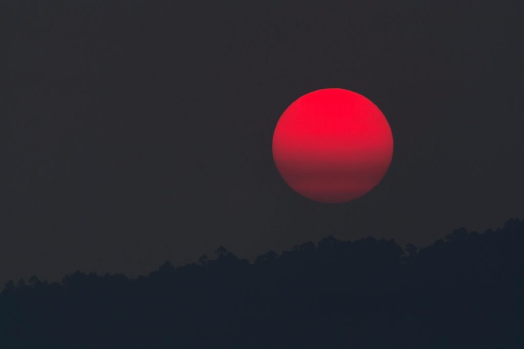pexels-photo-681467-681467 A captivating blood moon rising over a silhouette of hills, capturing the beauty of twilight.